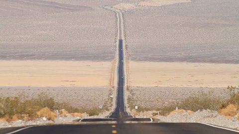 Static Shot of a Long Stretch of Road in the Middle of the Death Valley with Prominent Radiating Heat on the Ground