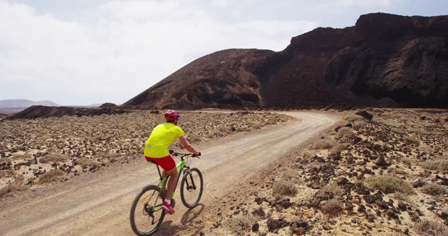 Mountain bike - man biking on MTB cycling trail. Man cycling enjoying healthy lifetyle and outdoor sports actvity. RED EPIC SLOW MOTION.
