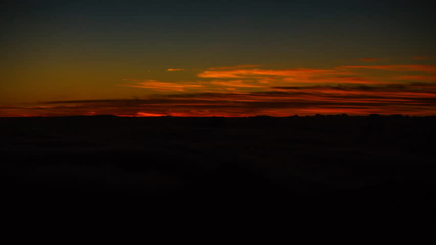 Time Lapse of Bright Sun Rising Above Sea of Clouds