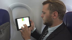 Business Man Checking Pie Chart on Digital Tablet Airplane Interior Travel Male - Powered by Shutterstock - Get 15% off with code: PIKWIZARD15