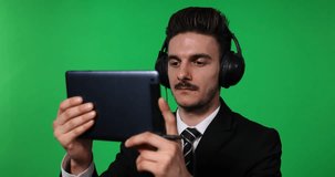 Business Man Watch Film Online Digital Tablet Headphones Green Screen Background
