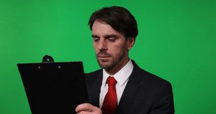 Confident Businessman Look Away Taking a Notes Clipboard Greenscreen Background