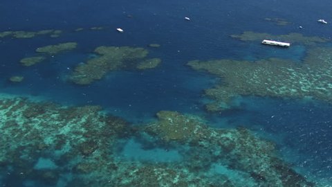 Aerial of the Great Barrier Reef, showing pontoons or snorkeling platforms on the reef