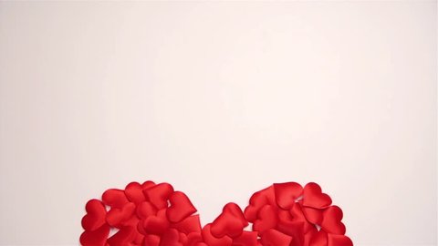 On a white background, many small red hearts are lined in the form of a big red heart. Valentine's Day. Celebration of love, congratulation wedding. Video footage. Camera moves from side to side.