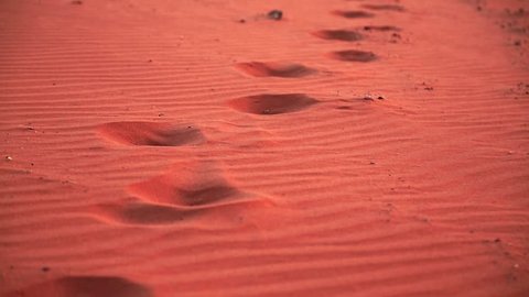 Footprints on the red sand in Wadi Rum desert, also known as The Valley of Moon, Hashemite Kingdom of Jordan