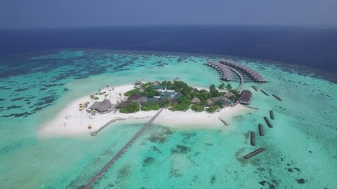 4k aerial video, bird eye view, drone fly over the Maldives islands. Small tropical island. Islands in the ocean. Palm. Ocean. Sky. White sand. Beach. Waves. Island. Islands. Tropics.