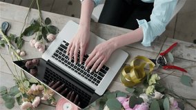 Office workplace essentials: laptop, paper notebook, bouquet of flowers on the rustic wooden table background, florist workplace, Flower business woman. - Powered by Shutterstock - Get 15% off with code: PIKWIZARD15