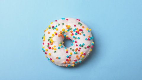 eating tasty donuts, time-lapse on blue background