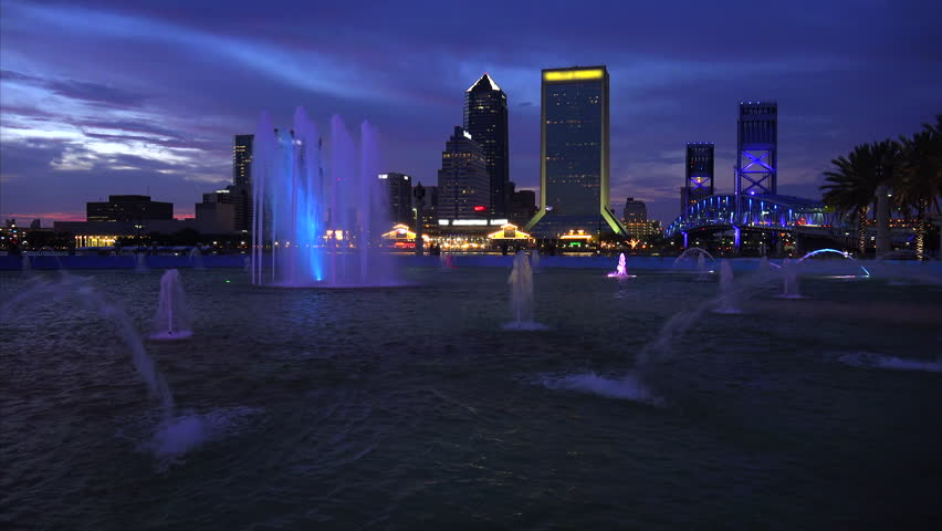Jacksonville, Florida city skyline and water fountain at sunset (logos blurred for commercial use)