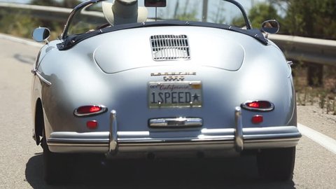 BIG SUR, CALIFORNIA, USA - CIRCA AUG 2015 - Man drives vintage Porsche down the California Pacific Coast Highway