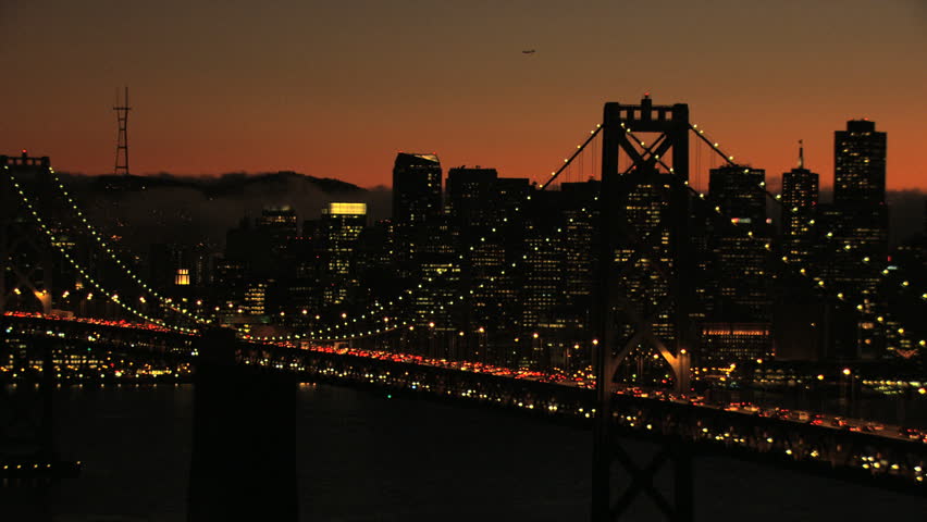 Aerial USA San Francisco USA Oakland Bay Bridge illuminated sunset city traffic Interstate 80 Ocean California