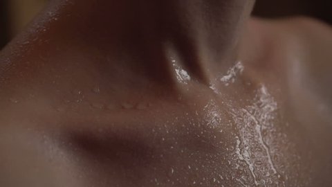 Girl relaxing in spa. Drops of water flow down the skin. Beautiful young female body. Female after fitness. close-up