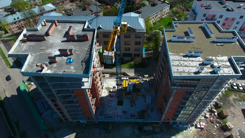 constuction crane on buildings with builders