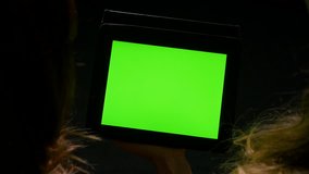 Two women having a debate with green screen tablet pc in hands