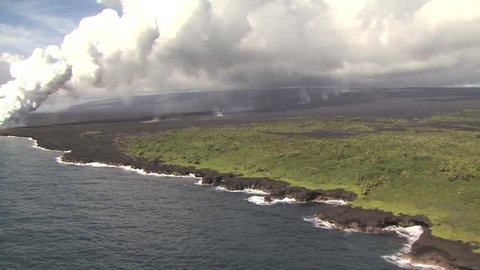 Aerial View Ocean and Volcanic Shore With A Massive Steam Cloud