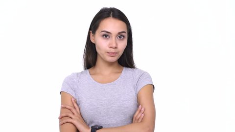Beautiful young confused asian woman standing in hesitation and changing her mind on white background

