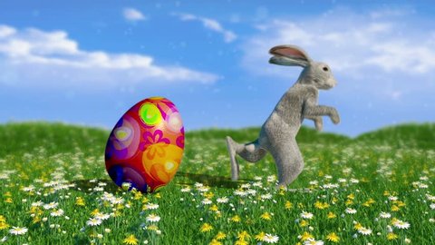 Bunny and Easter egg are dancing at the spring meadow among the flowers