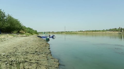 Pan right on Euphrates river at Karbala, Iraq. The Euphrates is the longest and one of the most historically important rivers of Western Asia.