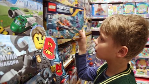 CHERNIHIV, UKRAINE - 01 APRIL 2017: 10 years old child chooses LEGO construction toys in shop.