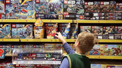 CHERNIHIV, UKRAINE - 01 APRIL 2017: 10 years old child chooses LEGO construction toys in shop.