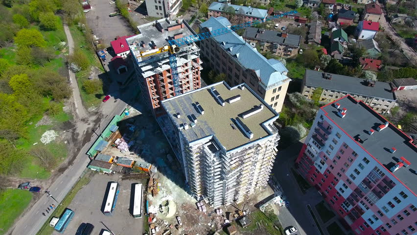 constuction crane on buildings with builders