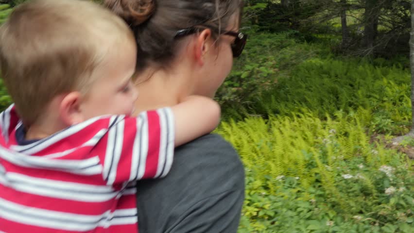 A family hikes on the skyline trail in Cape Breton Nova Scotia Canada at the famous Cabot Trail