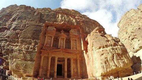 PETRA, JORDAN - circa JAN, 2017: High angle view of the facade of the Treasury building in the ancient Nabatean ruins of Petra, Jordan with tourists