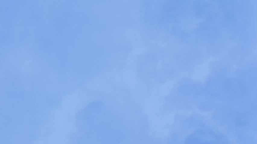 Moon time lapse during day time against blue sky.