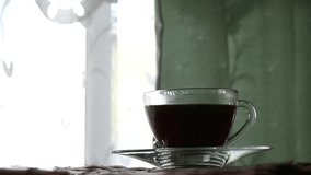 Cup of hot coffee indoor window blur background