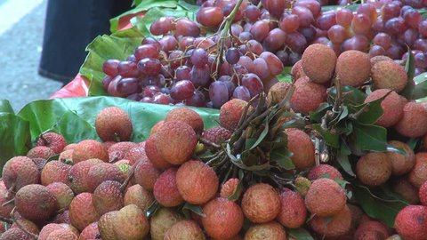 Lychee and grape for sale, street market, Hong Kong, China Stock Video