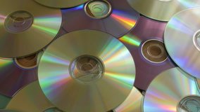 Optical Discs falling onto big pile of DVDs or CDs.