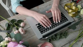 Office workplace essentials: laptop, paper notebook, bouquet of flowers on the rustic wooden table background, florist workplace, Flower business woman. - Powered by Shutterstock - Get 15% off with code: PIKWIZARD15