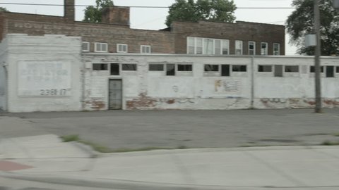 DETROIT, MI - CIRCA 2014: Driving plate: right side. Looking south on Michigan Avenue at commercial property and old train station.  Mid West USA, overcast, summer. 24mm lens, stabilized, part 2 of 2