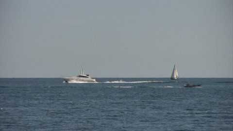 speedboats pass sailboats on lake - 1080i 