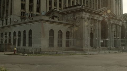 DETROIT, MI - CIRCA 2014: Driving plate: rear view. Looking south at abandoned Detroit Station with lens flares.  Mid West, USA.  Overcast, summer. 24mm lens, stabilized 1 of 2