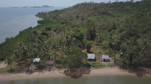 Aerial views of fishing village on Koh Tonsay (Rabbit Island) in Cambodia.  Camera pans across.