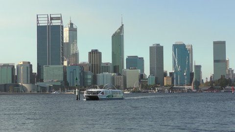 Perth, Australia; April 8, 2017: Ferry crossing Swan River opposite skyline of Perth city centre, capital of Western Australia, regional headquarter of mining and finance companies.