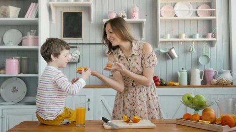 breakfast for an happy american family, mom and little child boy at kitchen