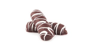 Fragrant cookies of choux pastry in dark chocolate covered 360 degree turning on the white background. Loop video
