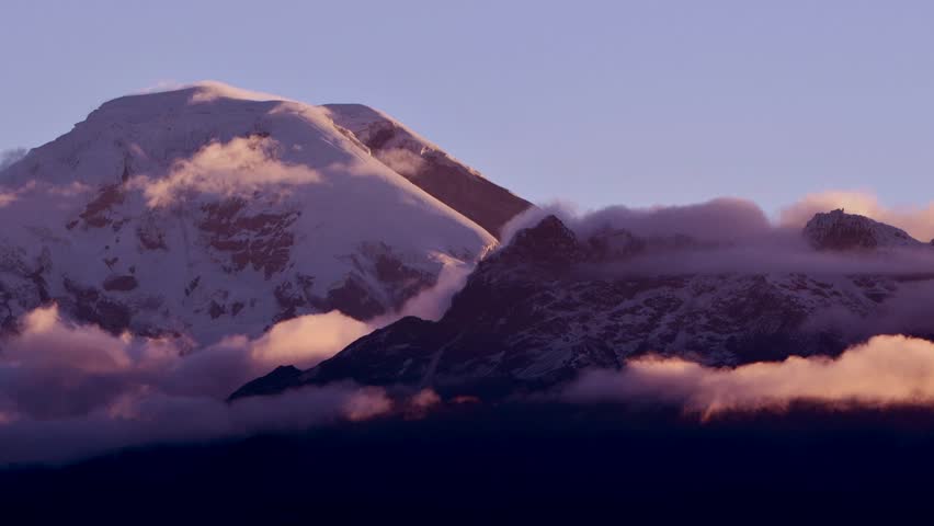 Sunset over the Chimborazo volcano in Ecuador. Time lapse zoom over the peak