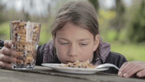 The boy is looking at cigarette butts in a plate. A teenager looks at cigarette butts. Anti tobacco video. For a healthy lifestyle. 
