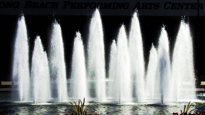 Relaxing jets of water glow in the sun at a modern urban fountain in Long Beach,