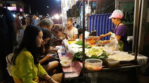 MAEHONGSON, THAILAND - APRIL 2 : 4K unidentified tourists eating Thai traditional food in night market in Pai district on April 2, 2017 in Mae Hong Son, Thailand.