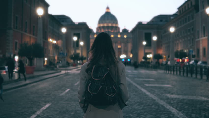 Young tourist woman walking in Piazza di spagna near the Saint Peter Cathedral. Girl looking around, exploring sights. Royalty-Free Stock Footage #25886900