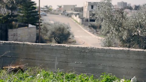 Car chasing kids running in Arab village