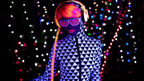 4k fantastic video of sexy cyber raver woman filmed in fluorescent clothing under UV black light