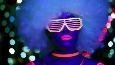 4k fantastic video of sexy cyber raver woman filmed in fluorescent clothing under UV black light
