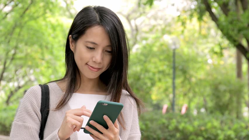 Young woman sending sms on mobile phone