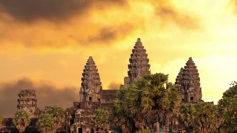 Angkor Wat temple silhouette with sunset sky and clouds
