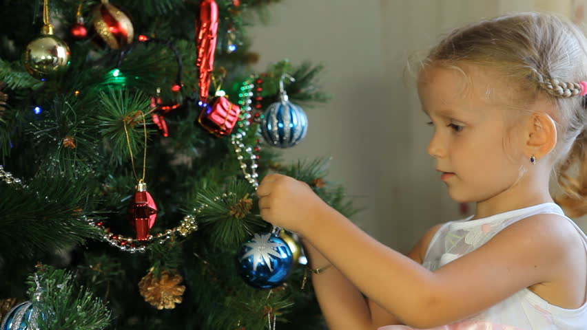 girl decorating christmas tree